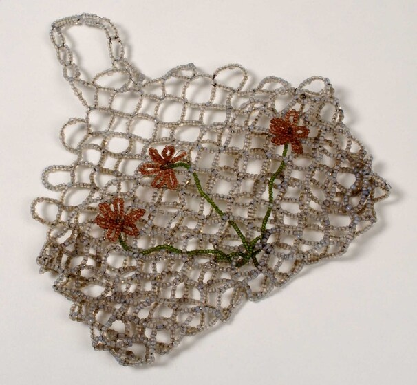 Silver beaded mesh purse with three yellow beaded flowers with green stems on the side.