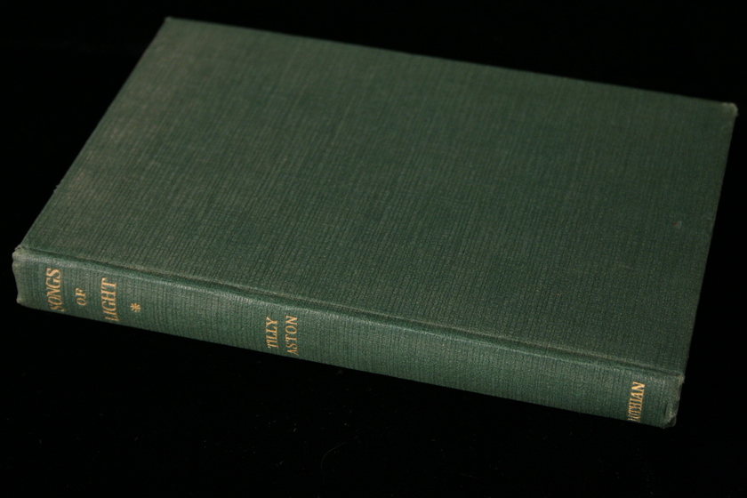 Green fabric covered book with gold writing on the spine.