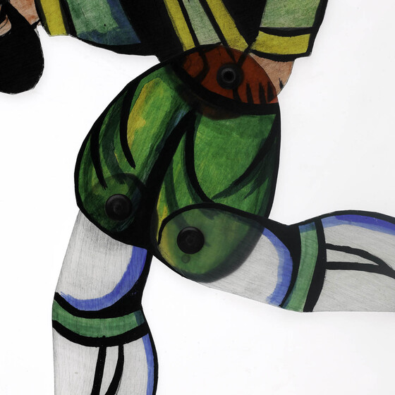 Close up detail of green shorts of an acrylic figure. The pins connecting legs are visible.