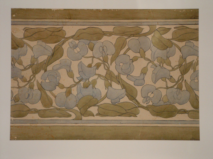 Repeating painted pattern of blue flowers with green leaves, bordered top and bottom by a green stripe.