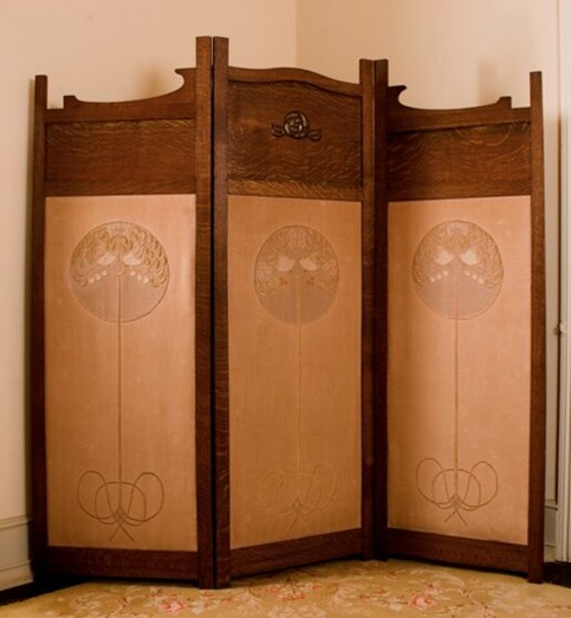Three fold timber free-standing screen. Each panel has a circular pattern at the top of a line design on the face