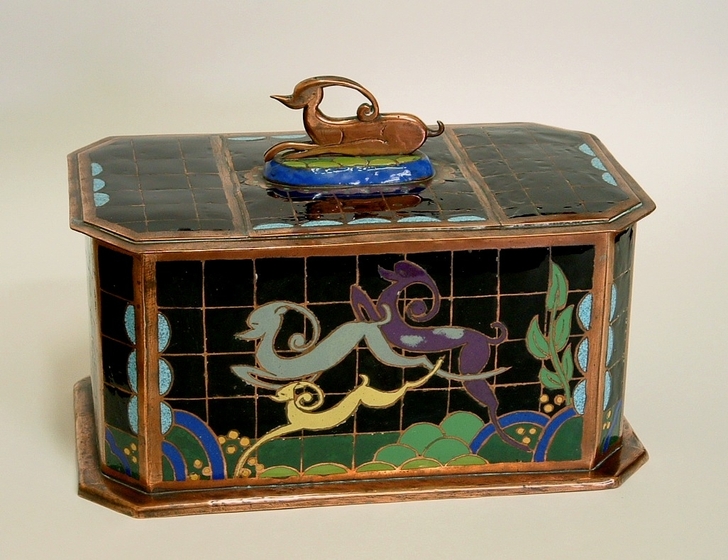 Small brightly coloured box with lid featuring three abstract coloured animals on the side, similar to deer, in yellow, blue and purple. A fourth animal of the same design sits on top forming a handle.  