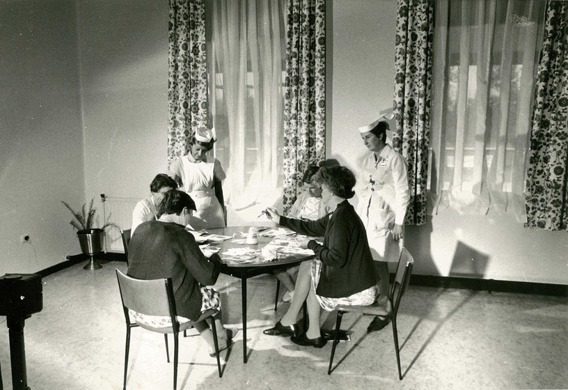 Four female patients working craft projects in a hospital ward. taken at Mont Park Psychiatric Hospital, Ward F3 in January 1971, two female nurses watch over the women as they work. 