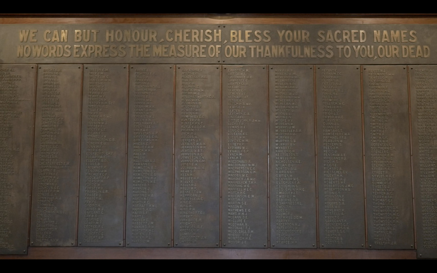 Honour board of brass plates attached to a wooden board with ten columns of names, each column with at least fifty names, heading to board reads "We can but honour, cherish, bless your sacred names. No words express the measure of our thankfulness to you, our dead."