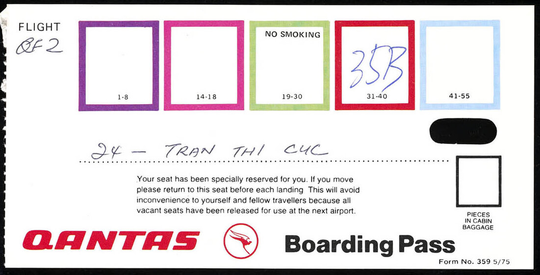 Qantas plane ticket with coloured boxes and 35B written in blue pen in a red box.