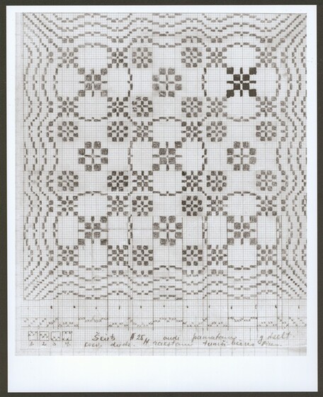 Geometric fabric pattern in a black frame, made from repeating circles and small squares. There are handwritten notes at the base of the framed image.