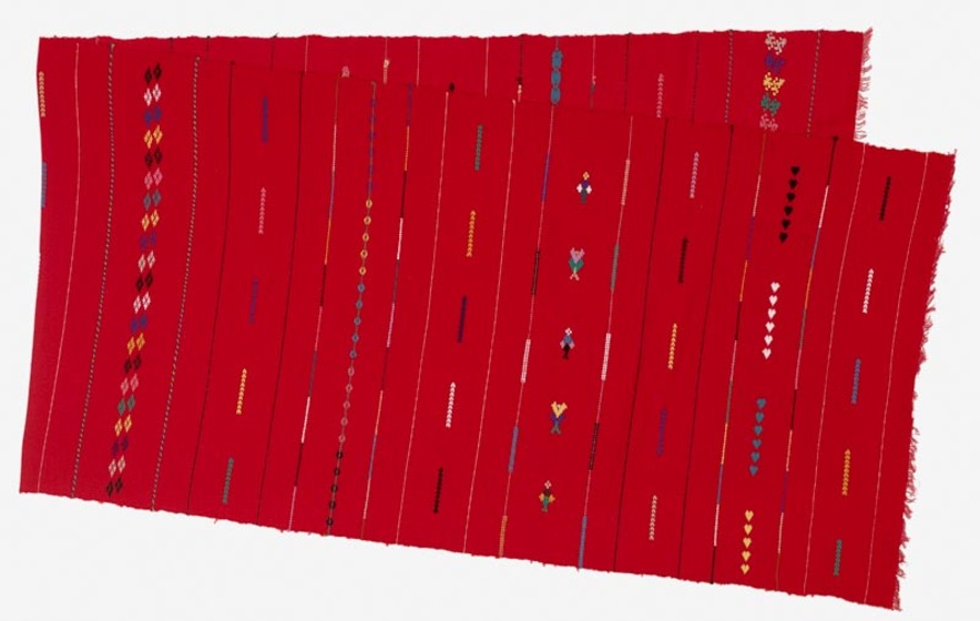 Length of red fabric with different stitches in coloured fabric run across it.