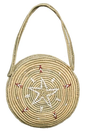 Round flat basket with handle, woven from plant fibers. Features white star painted in centre, with red and white chevron detail surrounding