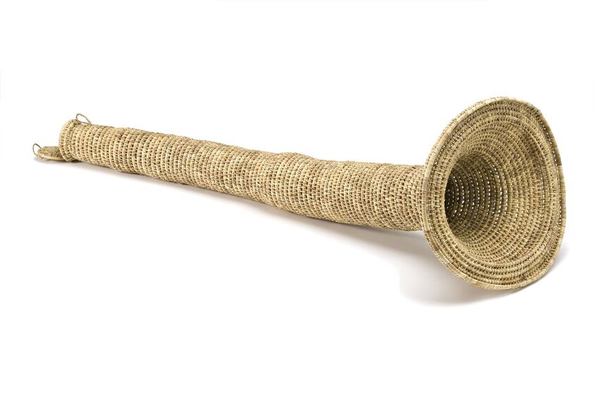 Thin eel trap with wide opening on one end, woven from plant fibers.
