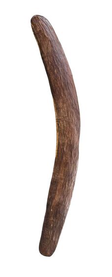Thin wooden boomerang carved as a lightly curved shape, with a rough surface showing the carving marks of its creation..