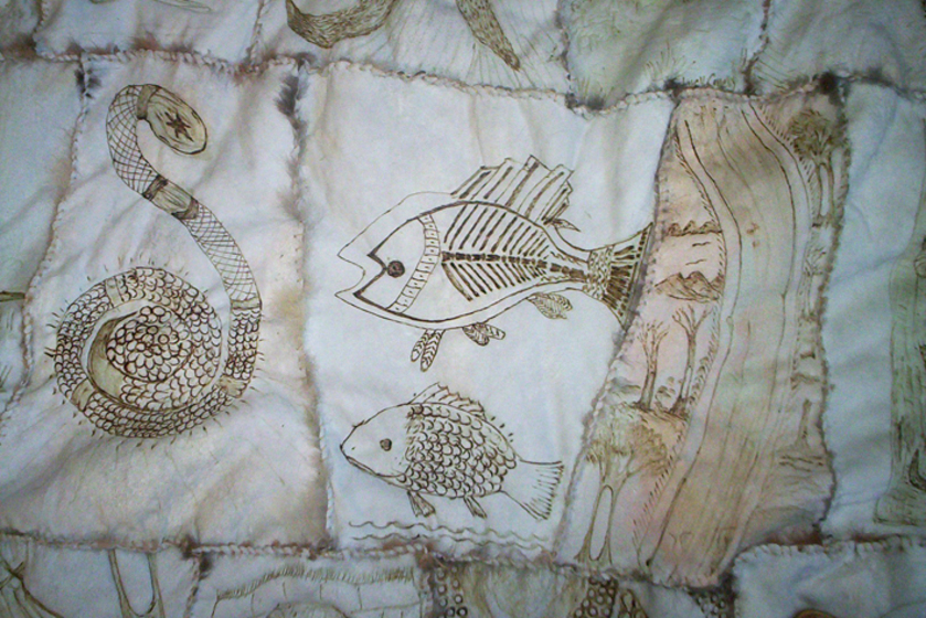 Close up of three panels from a possum skin cloak, showing a snake, fish, and river. 