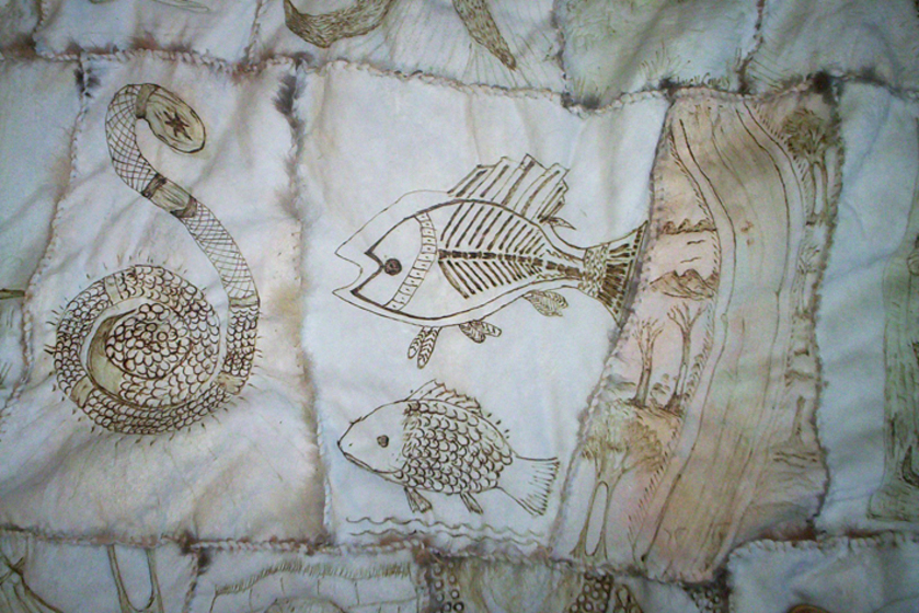 Close up of three panels from a possum skin cloak, showing a snake, fish, and river. 
