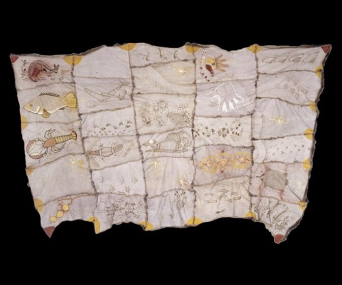 Cloak made with possum skin, stitched together in panels with each featuring a different design, including a crayfish, fish, kangaroo, hand prints, boomerang, and turtle