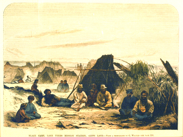 Colour historic print of a group of men seated in front of small tents and low bushes. Text below reads 'Black camp, Lakes Tyers Mission Station, Gipps Land'