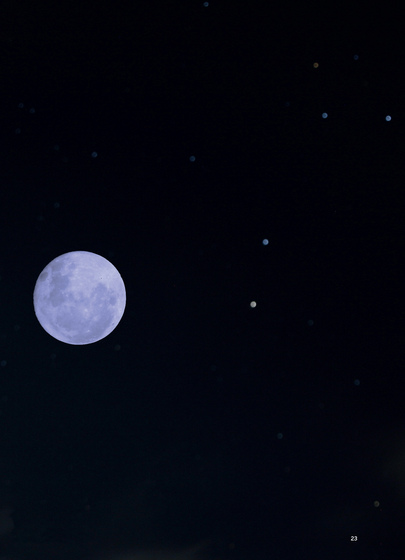 Full moon in a night sky with other stars nearby