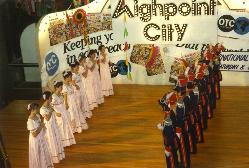 Eight couples in matching colourful traditional Polish costume dance on stage at Highpoint Shopping Centre