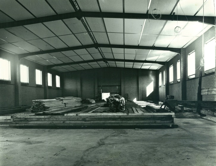 The interior of a large factory under construction, with building materials in view